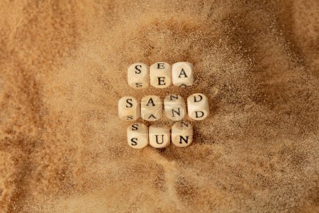 Photo for Alphabet letter wording "Sea Sand Sun" bead toy flying over explosion flying in air. Sea Sand Sun word alphabet letter show tropical island beach sand for vacation holiday. Top view action - Royalty Free Image