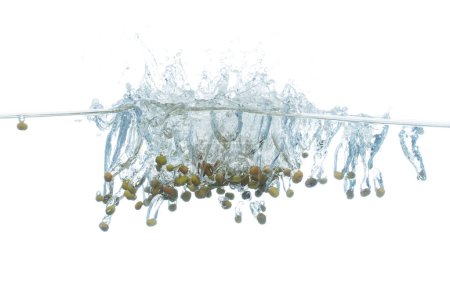 Photo for Green Beans falls into water and creates air bubbles on surface. Green beans drop hit smash to boil water and deep to bubble. White background isolated freeze motion - Royalty Free Image