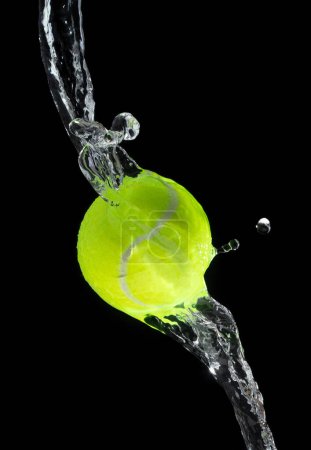 Tennisball trifft Wasser und spritzt in der Luft. Grüne Tennisbälle fliegen im Regen und Splatter-Spritzer plätschern im Tröpfchenwasser. Schwarzer Hintergrund isolierte Einfrieraktion