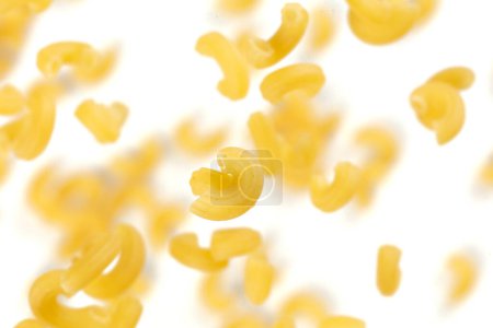 Photo for Macaroni flying explosion, yellow macaronis pasta float explode, abstract cloud fly. Curved macaroni pasta splash throwing in Air. White background Isolated freeze motion selective focus - Royalty Free Image