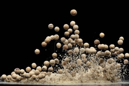 Photo for White Pepper seeds fly explosion, white Pepper mix powder float explode, abstract cloud fly. Peppercorn mix powder splash throwing in Air. Black background Isolated selective focus blur - Royalty Free Image