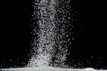 Photo for Pure Refined Sugar cube flying explosion, white crystal sugar abstract cloud fly. Pure refined sugar cubes splash stop in air, food object design. Black background isolated selective focus blur - Royalty Free Image