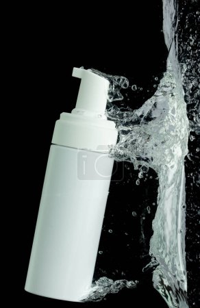 Photo for Cosmetic container fall into clear water with air bubble. Pump cosmetic treatment container drop to clear water of freshness. Black background isolated freeze element - Royalty Free Image