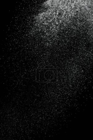 Photo for Million star dust of snow falling down from sky or roof, heavy big small size snows. Freeze shot on black background isolated overlay. Fluffy White snowflakes splash cloud in mid air - Royalty Free Image