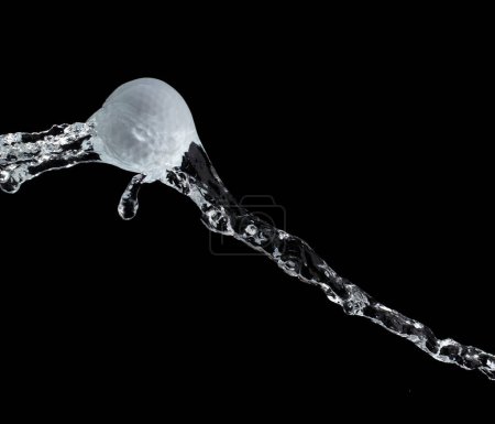 Photo for Golf ball hit water and splash in air. Golf ball fly in rain and splatter spin splash in droplet water. Black background isolated freeze action - Royalty Free Image