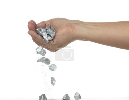 Photo for Silver ore nugget fall from industrial Miner hand fingers. Many pieces Silver nugget ore stone gravel found in hand of silver Mining industry. White background Isolated throwing freeze stop motion - Royalty Free Image