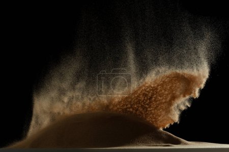 Photo for Sand blow like galaxy star in space. Sand dune hill over wind storm and blast dust splash over mountain. Sunshine rain fall on sand hill wind blow. Black background isolated - Royalty Free Image