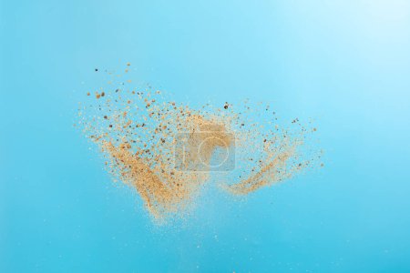 Photo for Big size Sand flying explosion, Golden grain wave explode. Abstract cloud fly. Yellow colored sand splash throwing in Air. Blue sky background Isolated, throwing freeze stop motion - Royalty Free Image