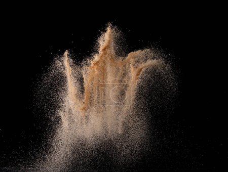 Photo for Natural Sand flying explosion, particle dot grain wave explode. Abstract cloud fly. Brown colored sand splash throwing in Air. Black background Isolated - Royalty Free Image