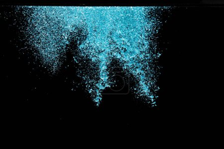 Photo for Explosion metallic blue glitter sparkle. sky Glitter powder spark blink celebrate, blur foil explode in air, fly throw blue glitters particle. Black background isolated, selective focus Blur bokeh - Royalty Free Image