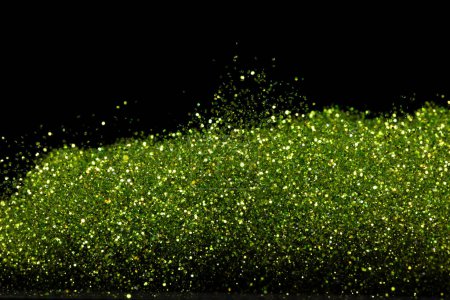 Photo for Explosion metallic green glitter sparkle. Green Glitter powder spark blink celebrate, blur foil explode in air, fly throw green glitters particle. Black background isolated, selective focus Blur bokeh - Royalty Free Image