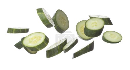 Téléchargez les photos : Cucumber fly fall, green fresh vegetable cucumber cut chop slice. Organic fresh vegetable with eaten leaf of long cucumber, close up texture. White background isolated freeze motion high speed shutter - en image libre de droit