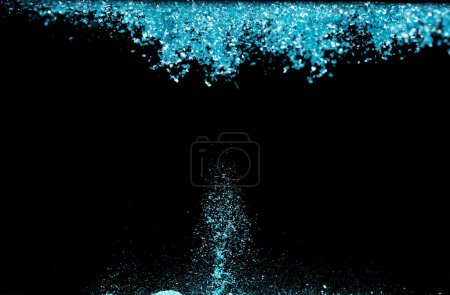 Photo for Explosion metallic blue glitter sparkle. sky Glitter powder spark blink celebrate, blur foil explode in air, fly throw blue glitters particle. Black background isolated, selective focus Blur bokeh - Royalty Free Image