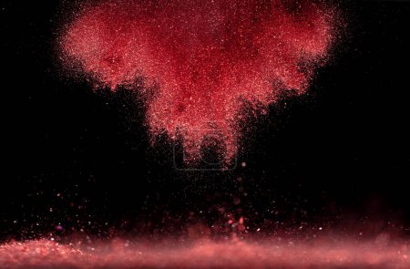 Photo for Explosion metallic red glitter sparkle. rose Glitter powder spark blink celebrate, blur foil explode in air, fly throw red glitters particle. Black background isolated, selective focus Blur bokeh - Royalty Free Image