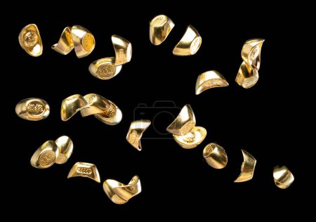 Photo for Chinese ornament gold ingot bar. Decoration element of chinese gold ingots or Yuanbao money for Festival. Other language mean rich wealthy prosperity. Black background isolated - Royalty Free Image