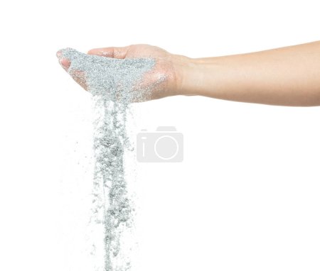 Photo for Silver metallic glitter sparkle fall from hand. Silver Glitter sand spark blink celebrate Chinese new year, particle pour from hand. White background isolated, selective focus Blur bokeh - Royalty Free Image