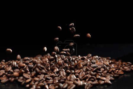 Photo for Coffee roasted bean fly explosion, Coffee crushed float pouring mix with beans. Roasted Coffee bean splash explosion in mid Air. Black background Isolated selective focus blur - Royalty Free Image