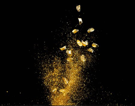 Photo for Gold Ingot Chinese Money bar token fly with dust particle in air. Chinese new year Yuanbao gold ingots floating to golden money sand particle. Language is wealthy prosperity. Black background isolated - Royalty Free Image