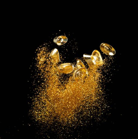 Téléchargez les photos : Gold Ingot Chinese Money bar token voler avec des particules de poussière dans l'air. Nouvel an chinois Yuanbao lingots d'or flottant à l'argent doré particules de sable. La langue est une prospérité riche. Fond noir isolé - en image libre de droit