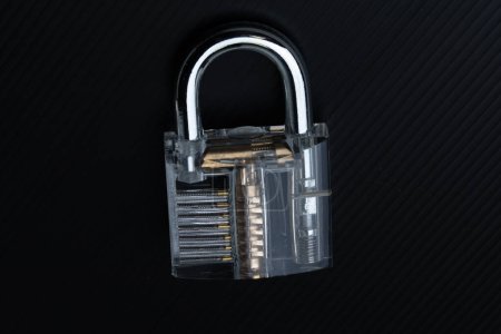 Clear Lock device over black background to show mechanic inside lock.