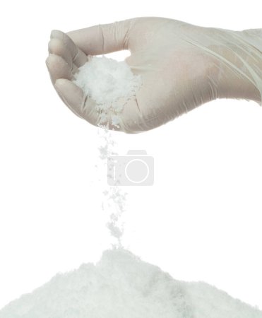 Téléchargez les photos : Le sel coulant tomber du doigt de la main, de grandes grandes fleurs de sels blancs explosent chute de nuage abstraite. tas de mélange de roche salée avec de la poudre moulue, conception d'éléments d'assaisonnement. Fond blanc isolé - en image libre de droit