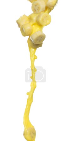 Foto de El jugo de plátano que vuela se cae, la onda amarilla del jugo de la rebanada del plátano picada explota. Color amarillo salpicadura de pintura lanzando en el aire. Fondo blanco Obturador de alta velocidad aislado, lanzando movimiento de parada de congelación - Imagen libre de derechos