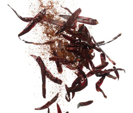 Dried Red hot Chilli fall down explosion, dried Red Chilli float explode, abstract cloud fly. Mix ground powder Chillis splash throwing in Air. White background Isolated high speed shutter, freeze