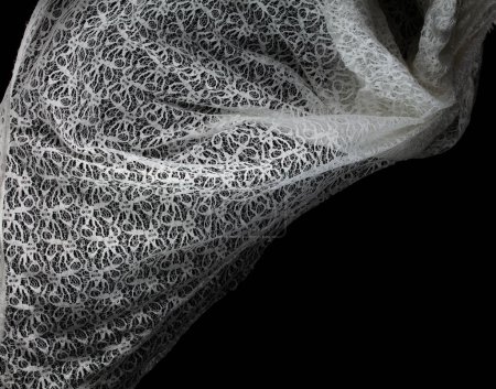 Photo for White lace fabric flying in curve shape, Piece of textile white lace fabric throw fall in air. Black background isolated, dark shading environment - Royalty Free Image