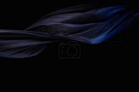 Photo for Blue silver shinny fabric flying in curve shape, Piece of textile blue silvery fabric throw fall in air. Black background isolated, dark shading environment - Royalty Free Image