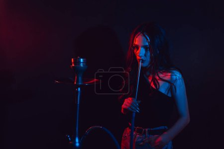 The theme of the hookah. young girl gets the pleasure of Smoking hookah