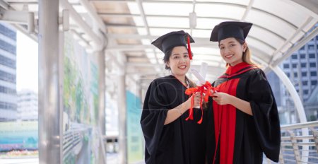 Photo for Happy student graduate hand holding diplomas and gold prize coin - Royalty Free Image