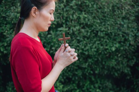 Photo for Asian woman praying with wood cross and believe in God - Royalty Free Image