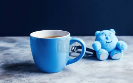 Photo for Blue bear with cup of coffee on blue background. Blue monday concept. Generative AI - Royalty Free Image