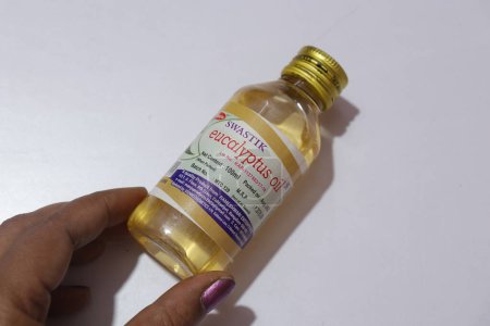 Photo for Eucalyphtus oil bottle in female hand - Royalty Free Image