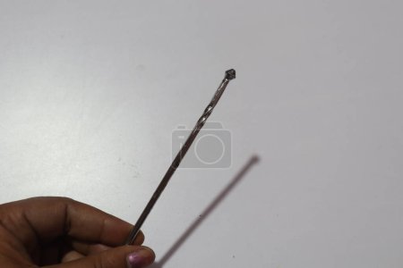 Photo for Hand showing metal knitting needle - Royalty Free Image