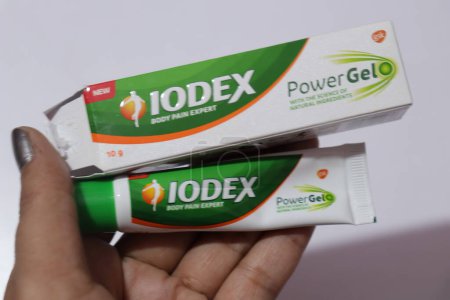Téléchargez les photos : Iodex gel contre la douleur corporelle avec boîte originale en paume féminine - en image libre de droit