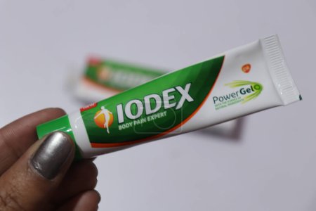 Photo for Female hand holding Iodex body pain gel - Royalty Free Image