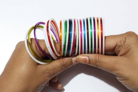 Photo for Close up view of colorful plastic bangles on white background - Royalty Free Image
