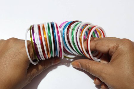 Photo for Close up view of colorful plastic bangles on white background - Royalty Free Image