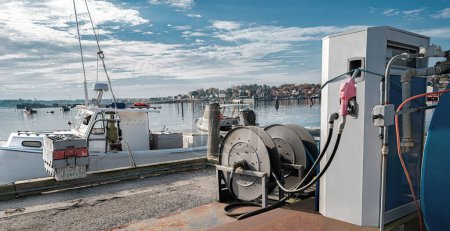 Dockside Fuel Station:  An industrial fuel pump is positioned to serve either boats or land vehicles at a waterfront site in New England.