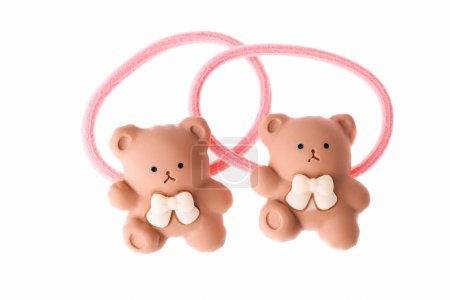 Pink hair elastic with teddy bear isolated on white background.