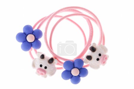 Pink hair elastic with cow and flower isolated on white background.