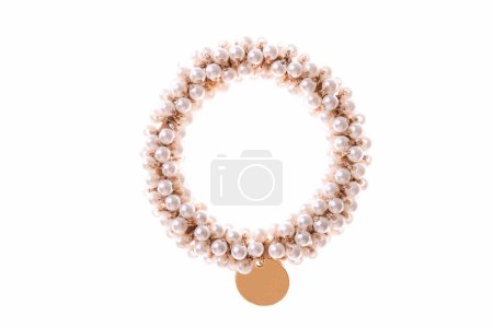 Hair elastic with beads and golden pendant isolated on white background.