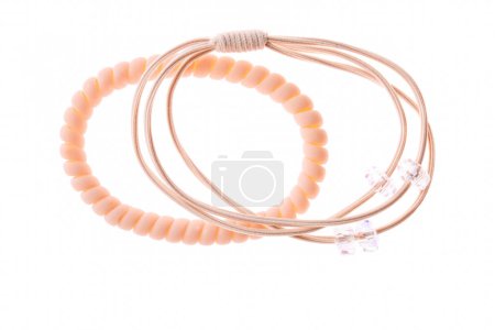Set of beige hair elastic with transparent beads isolated on white background.