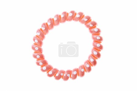 Pink hair elastic with dots isolated on white background.