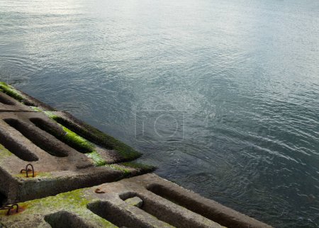 Photo for Coastal defense at the sea coast. Sea wall (seawall). Breakwater. Concrete blocks and stones. The Black Sea. Ukraine. - Royalty Free Image