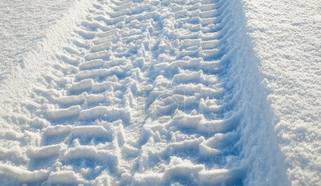 Photo for Wheel tracks on the snow surface. Sunny winter day. - Royalty Free Image