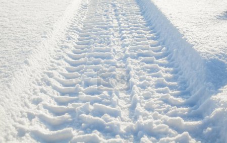 Photo for Wheel tracks on the snow surface. Sunny winter day. - Royalty Free Image