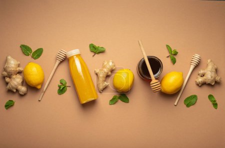 Photo for Composition with detox drink, lemons, mint, ginger, honey in glass jar, honey wooden dippers top view. Food for immunity stimulation and against flu. Healthy natural remedies to boost immune system. - Royalty Free Image