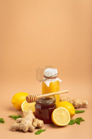 Photo for Composition with detox drink, sea buckthorn berries, lemons, mint, ginger, honey in glass jar. Food for immunity stimulation and against flu. Healthy natural remedies to boost immune system. - Royalty Free Image